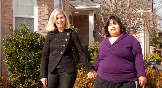 Pat and Mia Nobbie in front of Mia's house