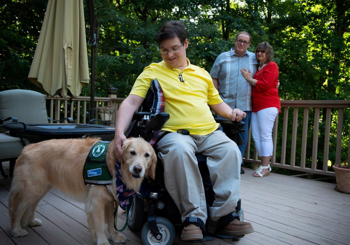 Tim Beighley with his service dog, Ringer and his parents, Doug and Angie Beighley, at their Marietta home.