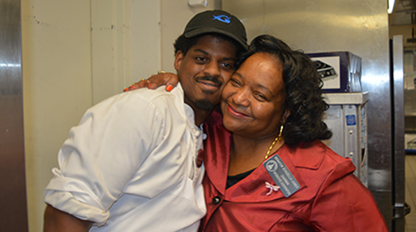 Legislator visits man with developmental disabilities at his job at the Georgia Aquarium.