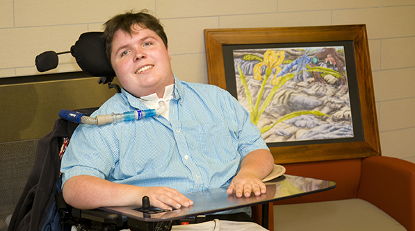 Person with disabilities in a wheelchair with assistive technology.